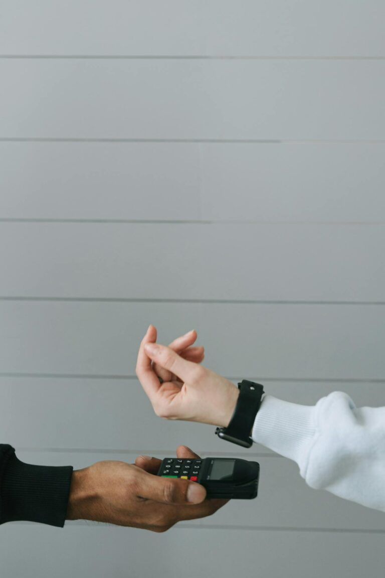 Close-up of a smartwatch being used for a contactless payment at a digital card terminal.