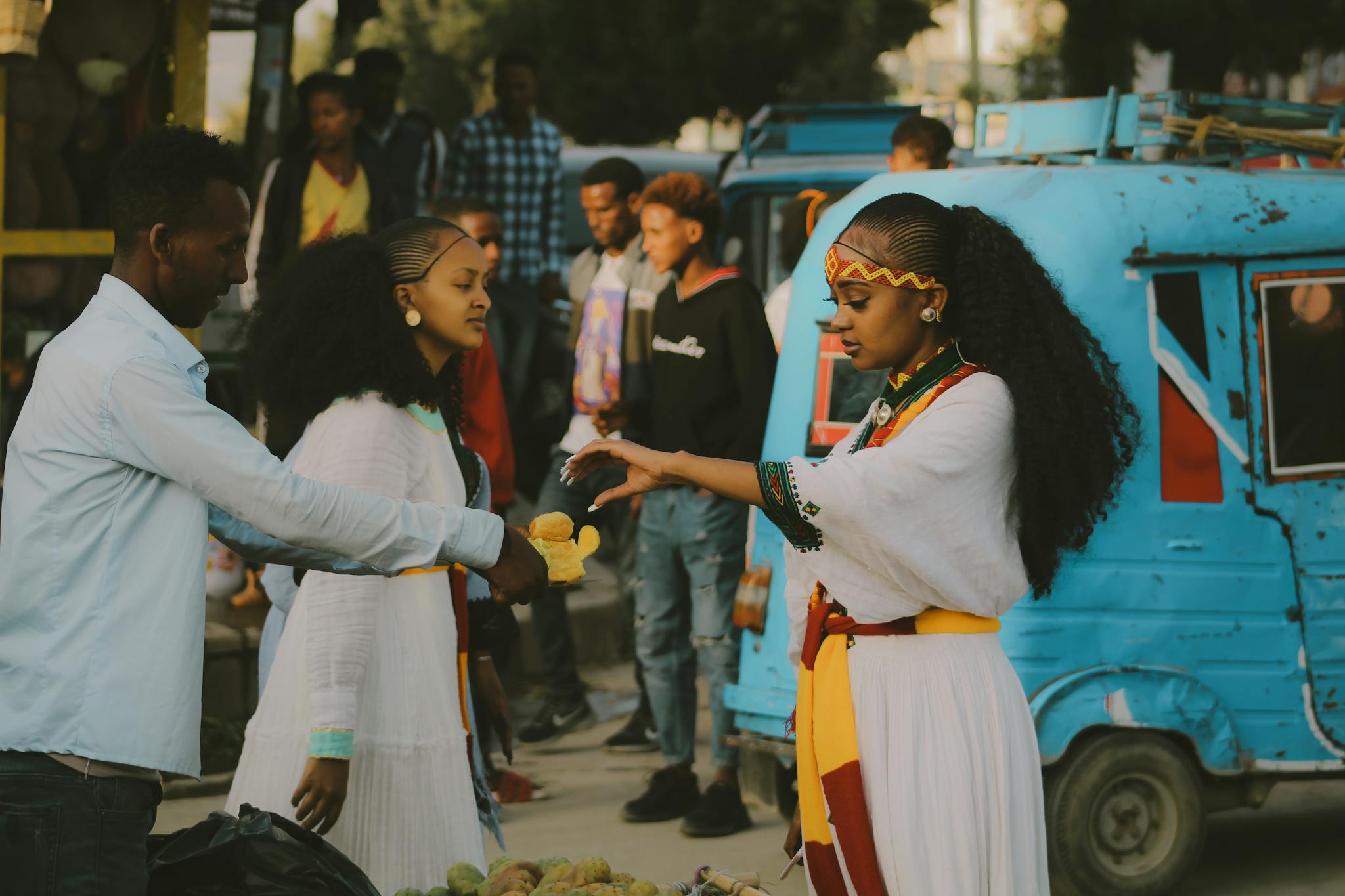 Street scene capturing a traditional exchange at a local market, vibrant and lively.